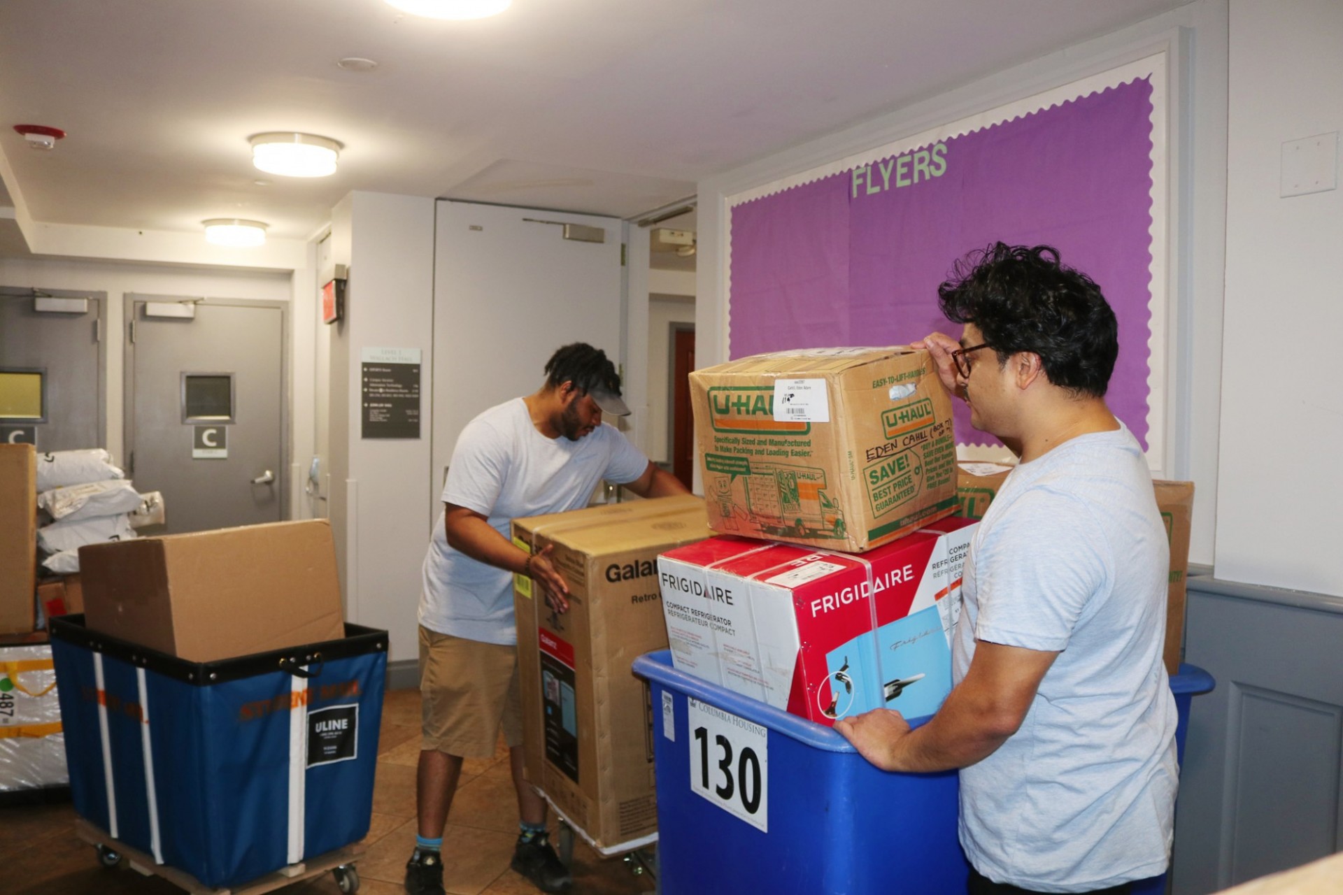 Bins of packages being delivered to the residence halls