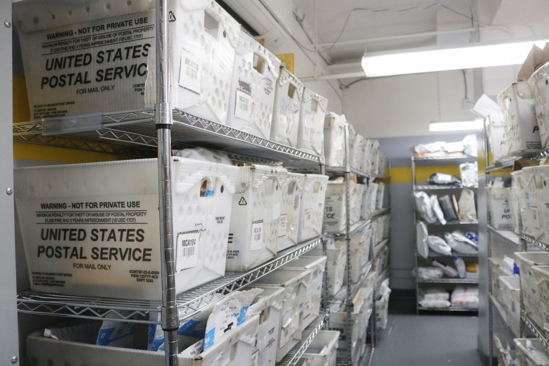 USPS bins of letters stacked in the Mail center