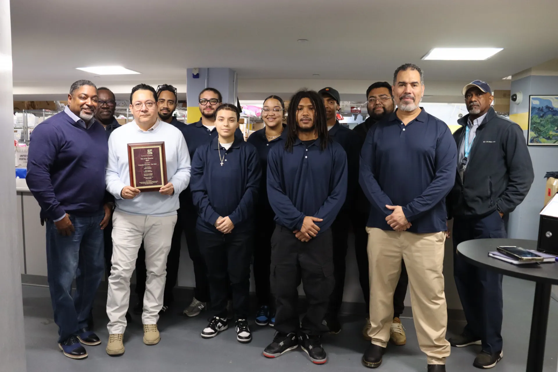 Mail staff members pose with the award at the Student Mail Center