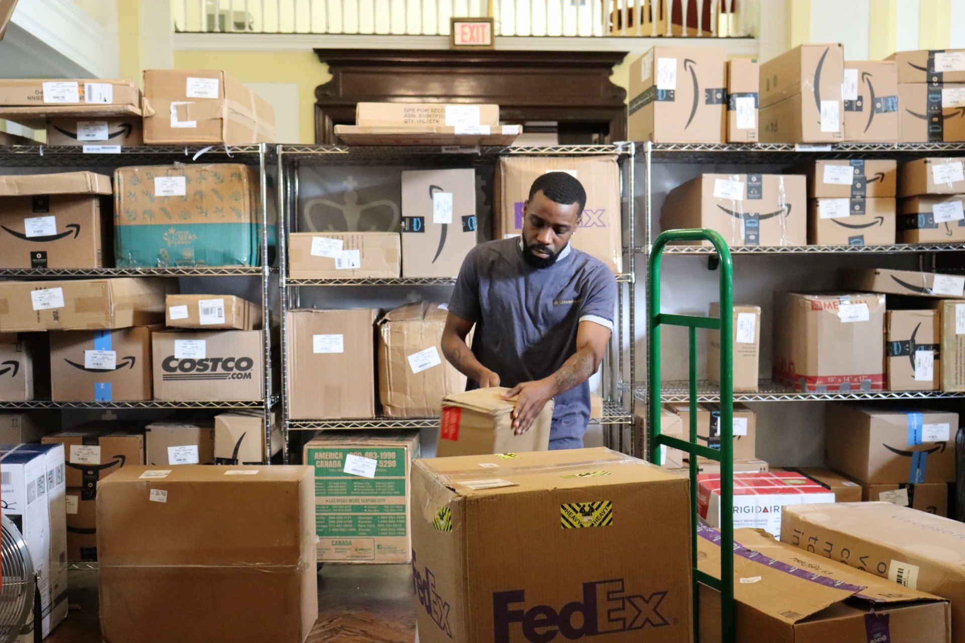 Mail employee receiving and sorting packages arriving to Wien Hall lounge