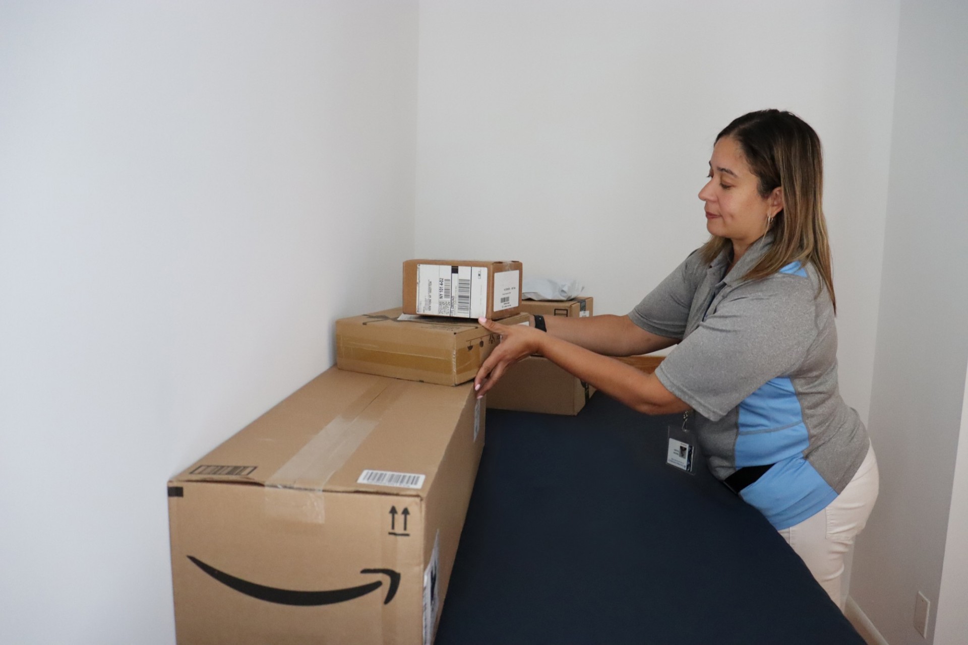 Mail team member delivering a student's packages to their room