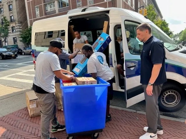 The Student Mail team loads packages into a van for delivery to the residence halls.